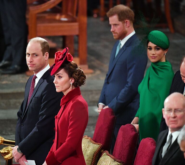 Prince Harry and Meghan Markle sitting behind Prince William and Kate Middleton