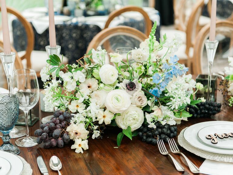 White flowers red grapes wedding table centerpieces