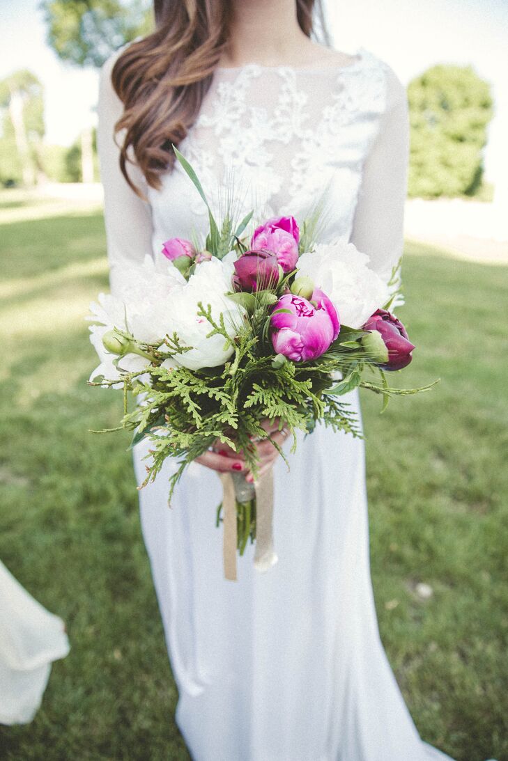 For her bouquet, Lauren picked a loose arrangement with vibrant hues. White, burgundy and fuchsia peonies as well as greenery from Risher Van Horn Flowers overflowed from its champagne ribbon wrap. The design looked as if it had just been picked.