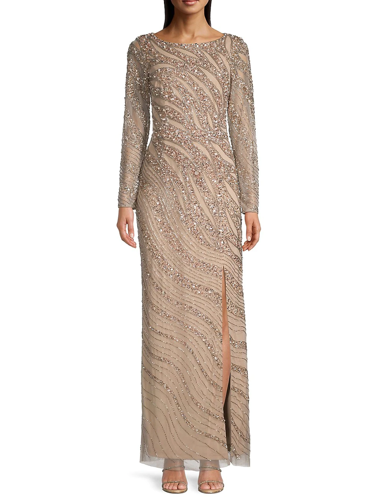 A model wears this long-sleeved neutral-toned gown with metallic embroidery.