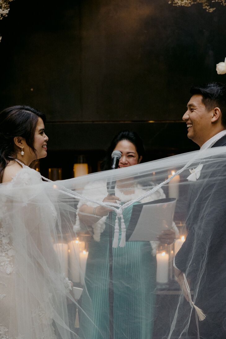 Filipino Cultural Ceremony Tradition of Wrapping a Veil Around Bride and Groom Representing Unity