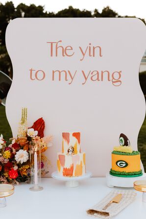 Dessert Table With Colorful Bride's Cake and Green Bay Packers Groom's Cake