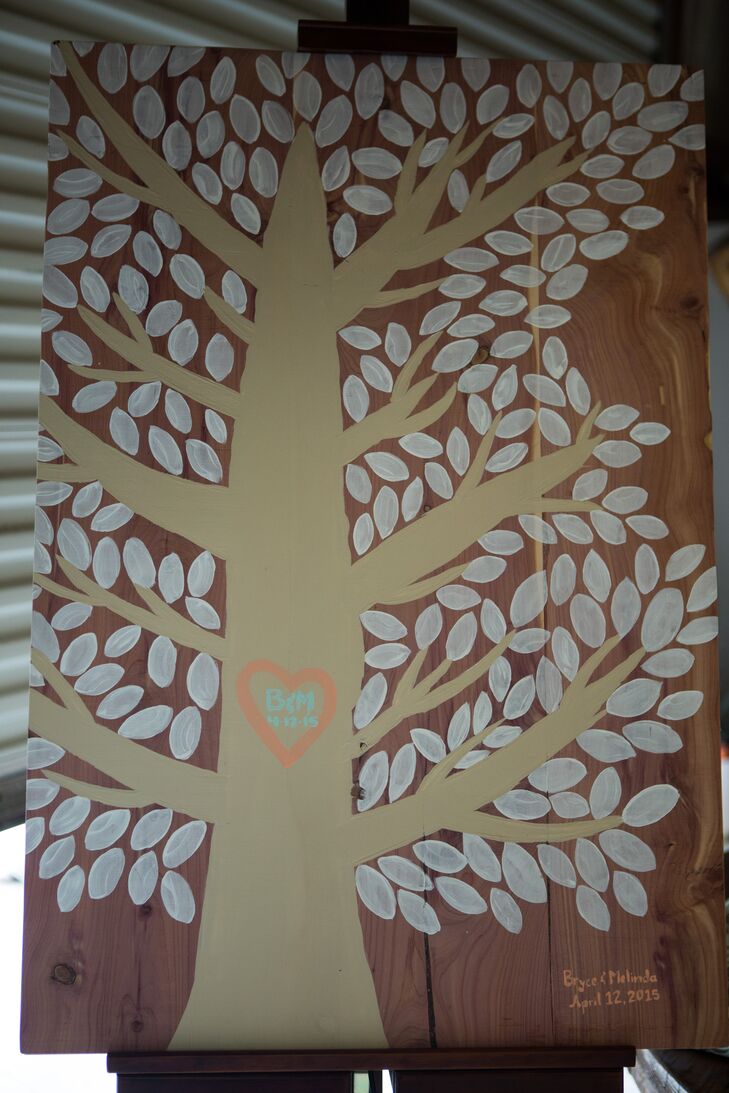 The bride painted a tree on cedar boards left over from the building of the ceremony site. Guests signed their names on the leaves of the tree.