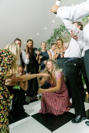 Guests and Friends in Formal Attire Dancing and Getting Low on Checkered Dance Floor Under Tent