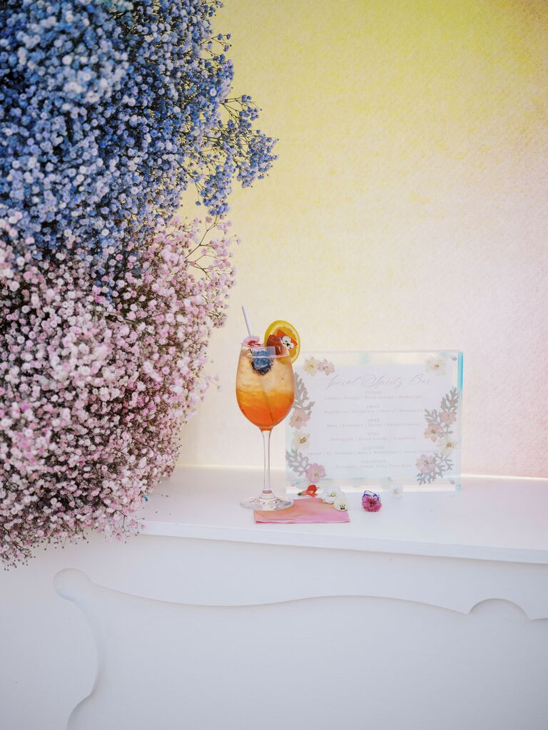 Aperol spritz next to spray painted baby breath flowers.