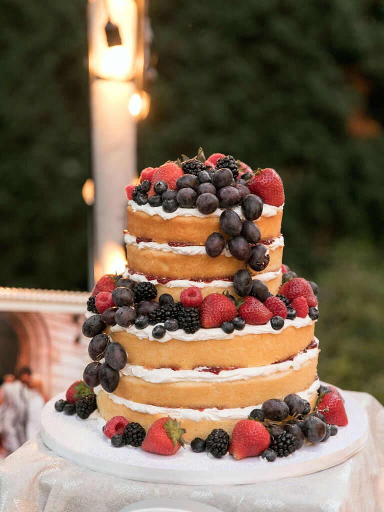 naked wedding cake with buttercream filling and fresh grapes, blackberries, strawberries, raspberries