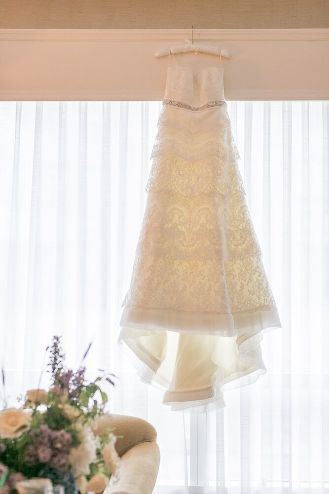 When Alexandra showed her consultant at Kleinfeld the styles of wedding dresses she liked, the consultant knew the exact dress for her and brought her a beautiful Rivini tiered lace gown. "Each layer was a different lace and the shape cascaded perfectly, showing off my waist while not hugging everything," Alexandra says. "Both my mom and I teared up when I put it on."