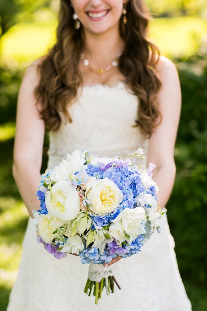 Alexandra carried a beautiful round bouquet, created by the wedding day florist, Rebecca Shepherd Floral Designs, of peonies, roses, irises and hydrangeas matching the vintage-inspired color palette of soft blue, purple and green.