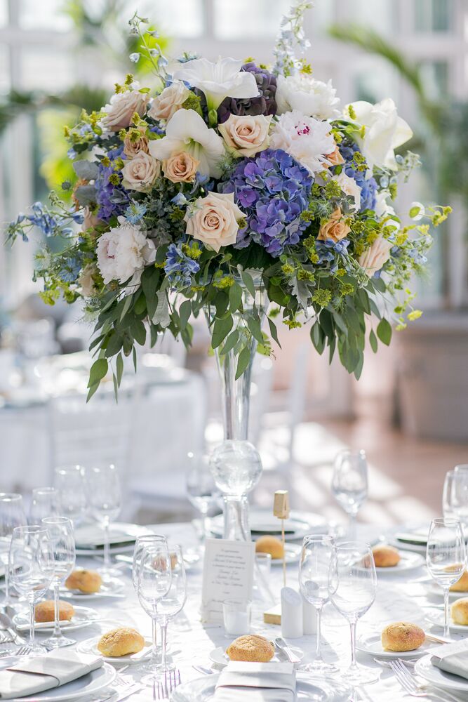Alexandra and Will chose a color palette of soft blue, purple and green with pops of pink and light coral for their whimsical, vintage wedding. Their florist, Rebecca Shepherd Floral Designs, created the beautiful arrangements of roses, peonies, irises and hydrangeas keeping with these colors.