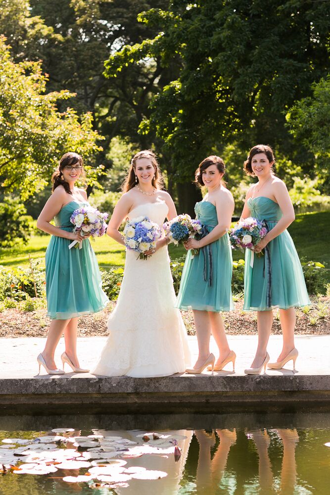 Alexandra's bridesmaids wore knee-length, green chiffon dresses from Bella Bridesmaids. "Initially I was going to let my bridesmaids choose their own style of dress in the same color and fabric, but in a happy accident, all three chose the same dress," Alexandra says.