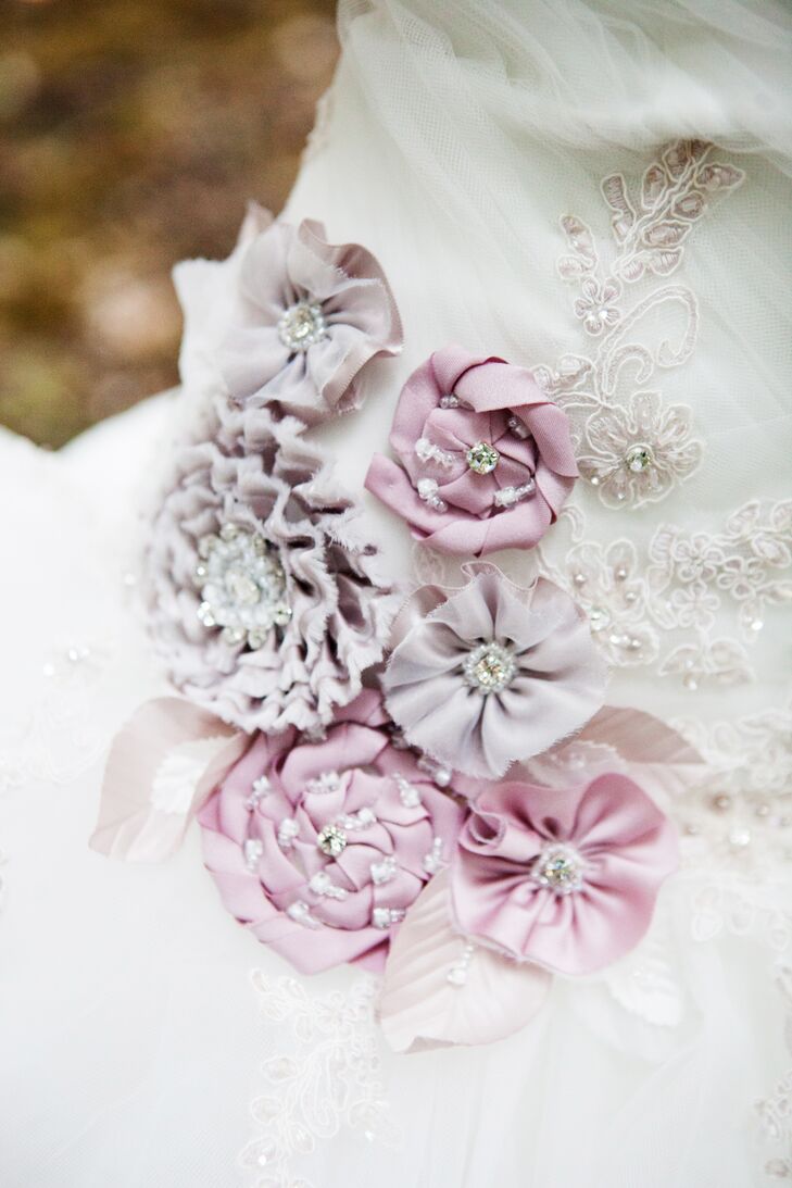 Satin and organza flowers in shades of purple with rhinestones, crystal beading and sequins provided the perfect touch for the bride's Alfred Angelo Sleeping Beauty dress.