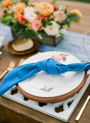 Blue Tied Linens on Lattice Chargers with Gold Flatware