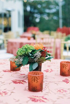 Tabletop With a Red Linen, Floral Pattern, Low Centerpiece and Small Candles With Patterns