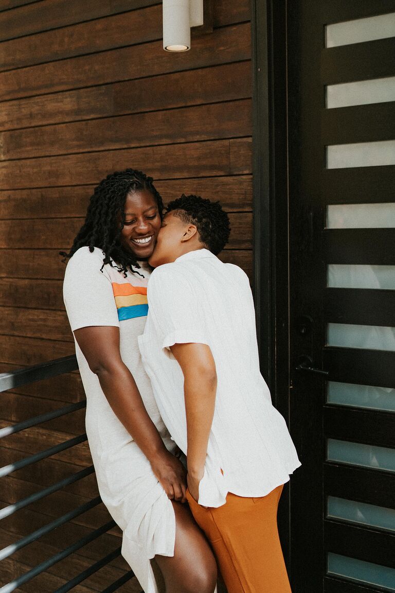 Couple snuggling during relaxed engagement photo shoot