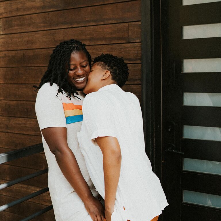 Couple snuggling during relaxed engagement photo shoot