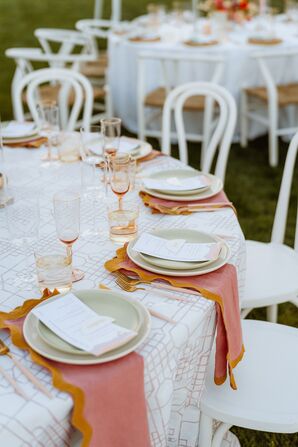 Patterned Table Linen, Pink-and-Yellow Napkins and Neutral Chargers With Menus