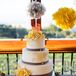 Gray sugar ribbon wrapped the three tiers of the cake. Subtle floral details topped each layer, while sugar flowers finished the look.