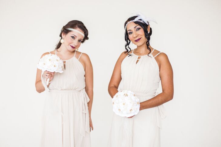 Of course, the bridesmaids also played the part of Gatsby-esque ladies with fun accessories. Each woman wore a neutral halter-strap dress with a pleated skirt and sash along the empire waist. For some added art deco flair, they rocked bold plum lipstick, pearl headbands and refined curled hairstyles. They even matched Jaris with handmade fabric rose bouquets.