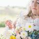 Bride Admiring Her Lush Bouquet of Colorful Wildflowers