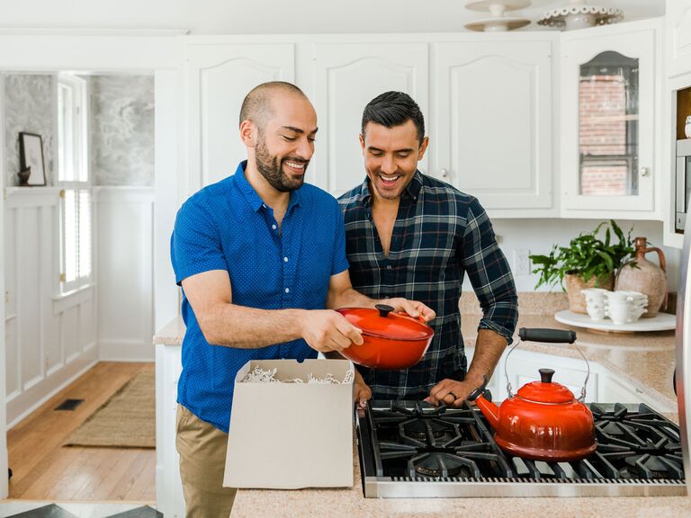 Couple opening wedding registry gifts at home