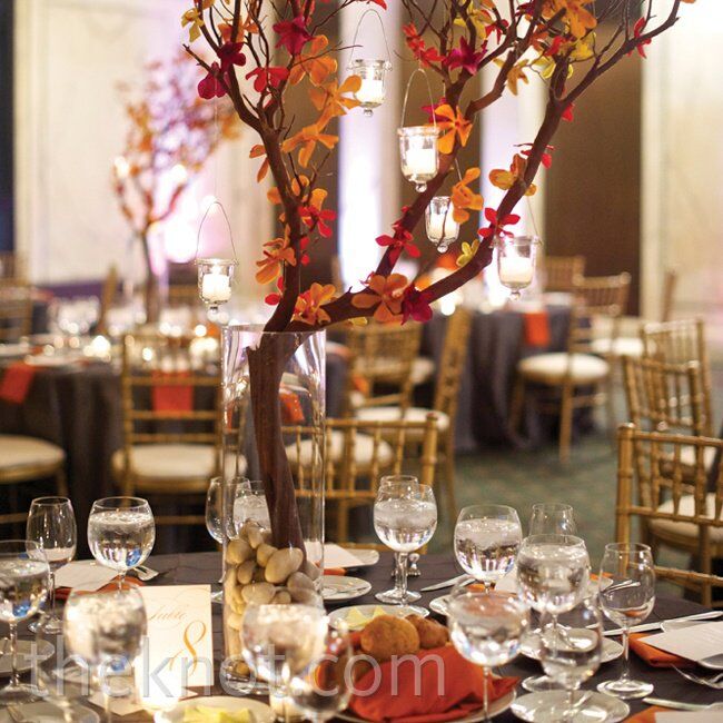 Some of the dinner tables got a boost in height from tall manzanita branches covered in orange orchid blooms and hanging candles.