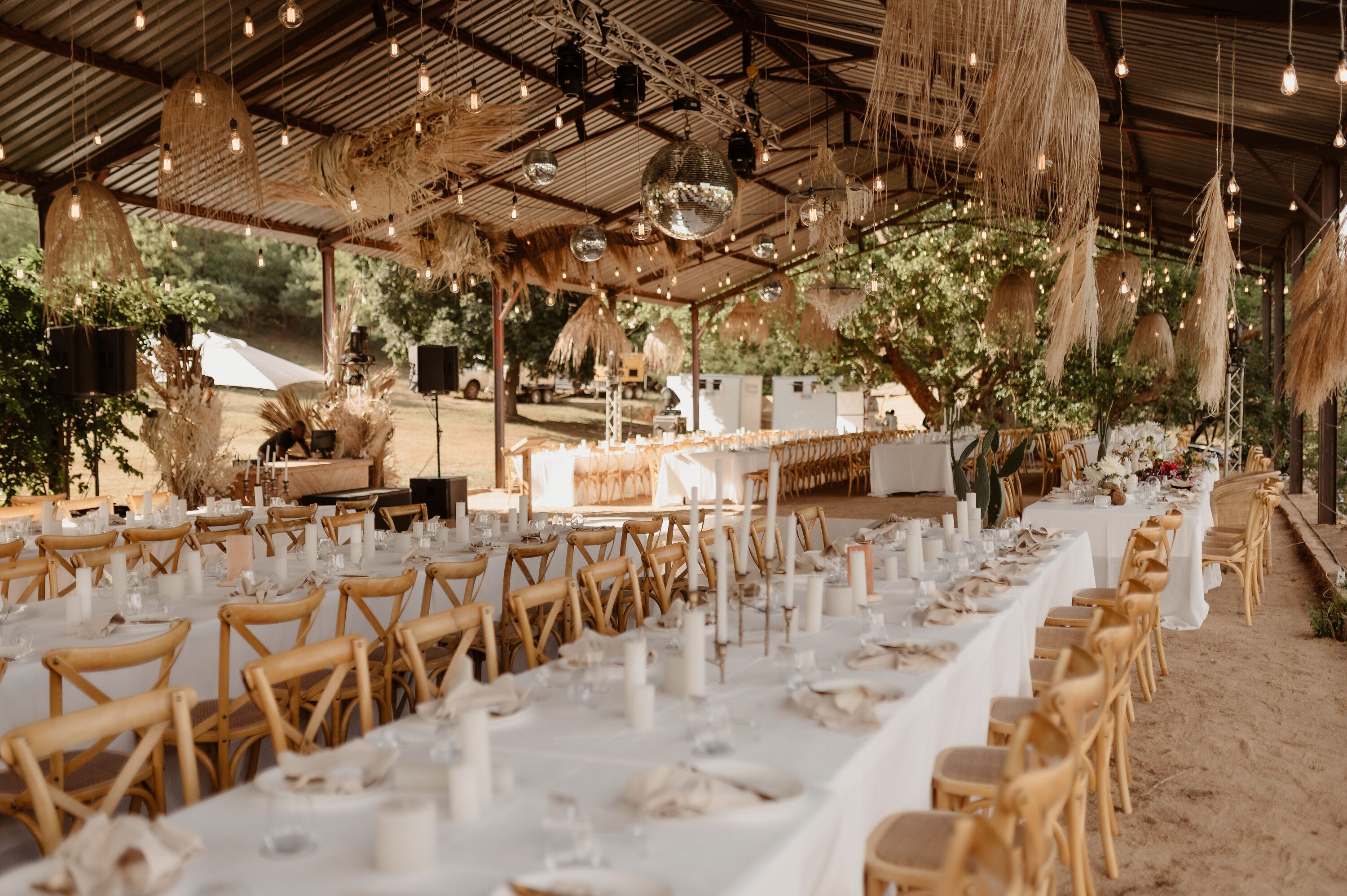Gazebo With Disco Balls, String Lights, Grass Chandeliers Over Long Tables, White Linens and Candles