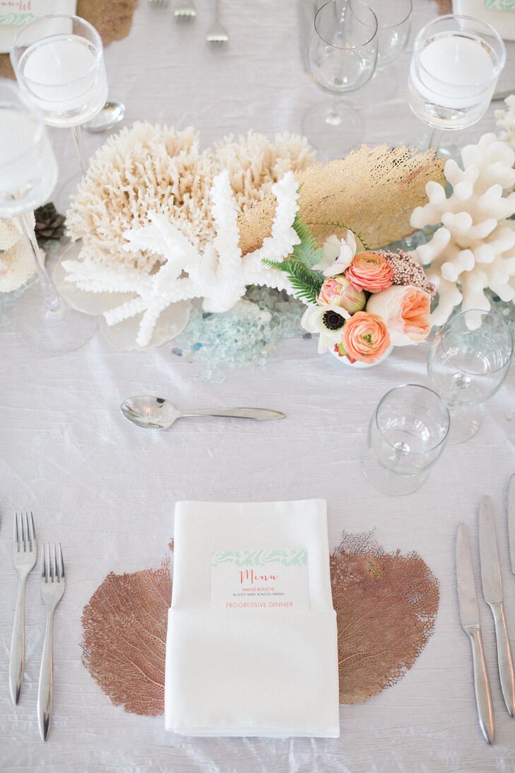 Their 20-foot head table was filled with tokens from the sea. “I’m so obsessed with how it turned out,” Stephanie says. Centerpieces of actual sea coral in white and neutral tones, as well as sea fans and blue sea glass, formed the tablescape. It didn’t stop there. Guests' napkins were placed on sea fans for an unexpected twist.