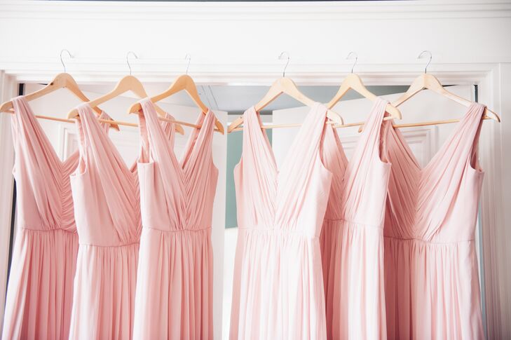 Bridesmaids wore long, floor-length blush dresses in V-neck styles for a flowing, romantic look throughout the ceremony and reception.