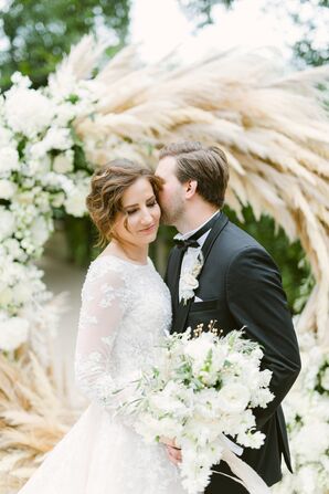 Couple Posing in Front of Pampas Grass Wedding ARch
