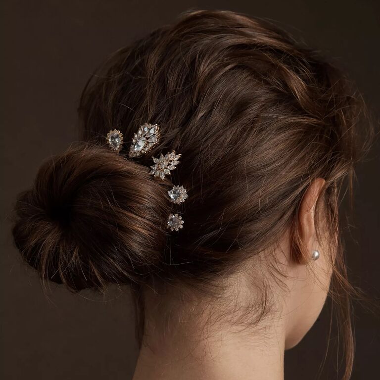 Model wears beautiful bedazzled pins in her updo. 