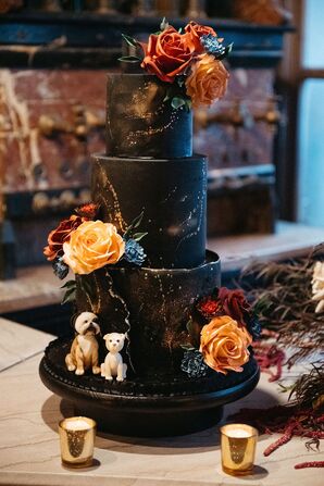 Black, Three-Tier Wedding Cake With Gold Splatter Patterns, Red and Gold Flowers