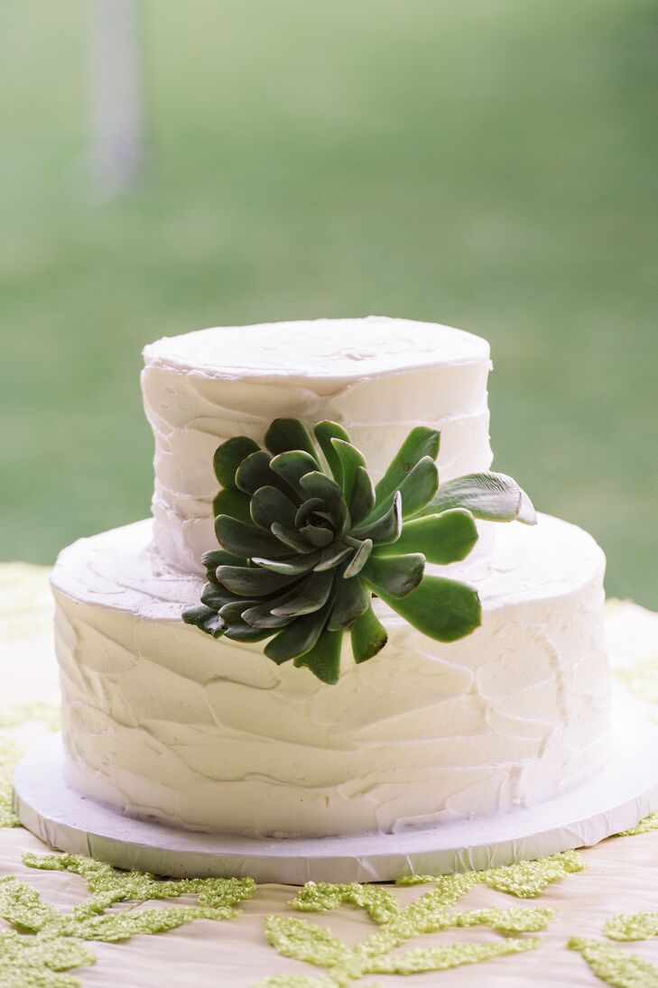 Sometimes adding a bold floral to an otherwise plain dessert can really make it stand out. Caroline and Christopher knew they wanted a simple wedding cake, so they picked a two-tier ivory confection from Fatty Patty's Cakes & Cafe. The round layers were covered with buttercream frosting and then topped with a single succulent at the center.