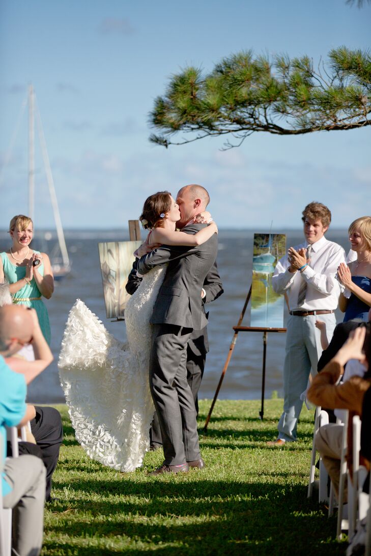 The setting of a Southern, waterfront wedding helped to guide Shelly's wedding attire. She found her petal-covered dress in Los Angeles and imagining the petals fluttering in wind off the water sold her!