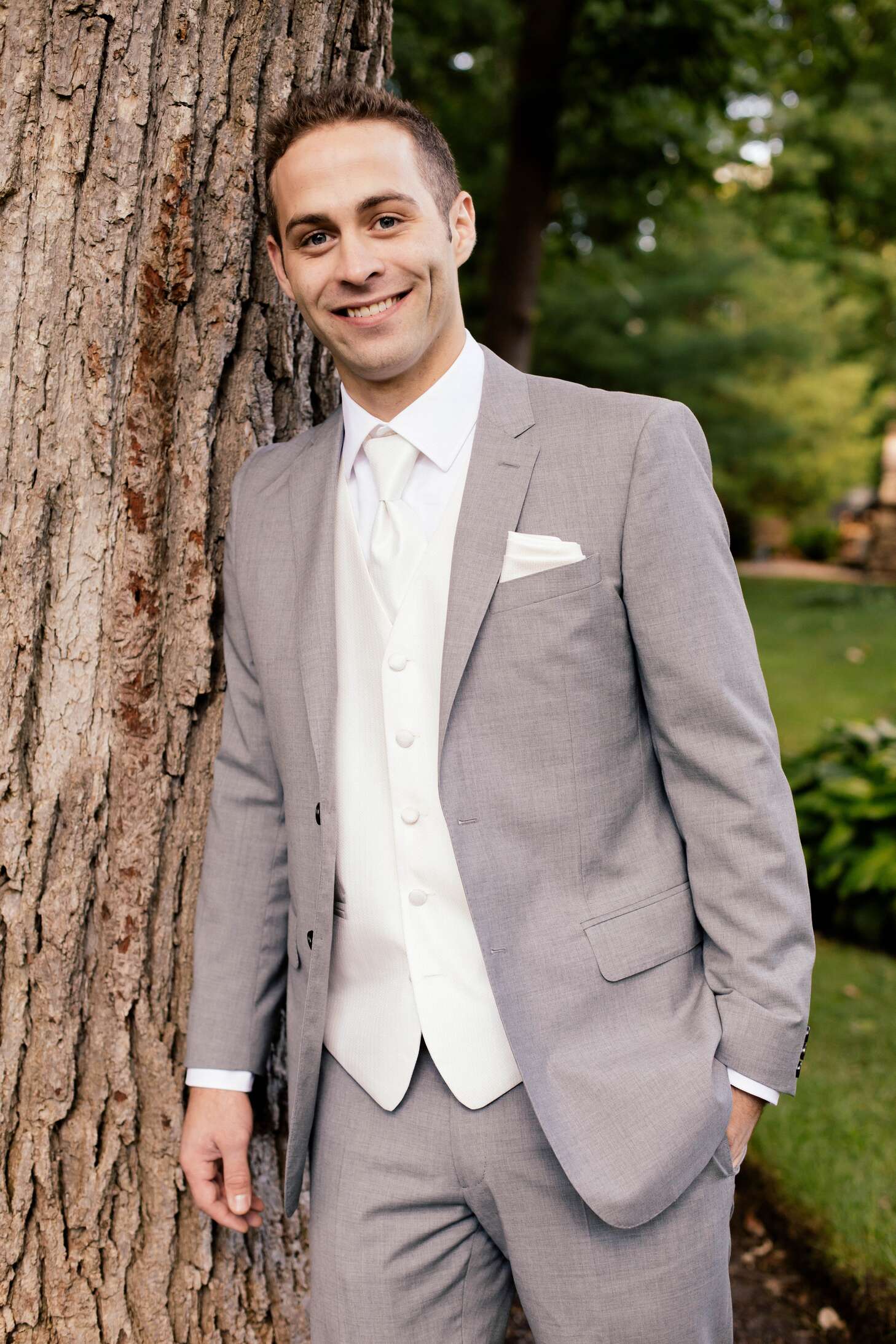 Groom In A Gray Suit With A White Tie