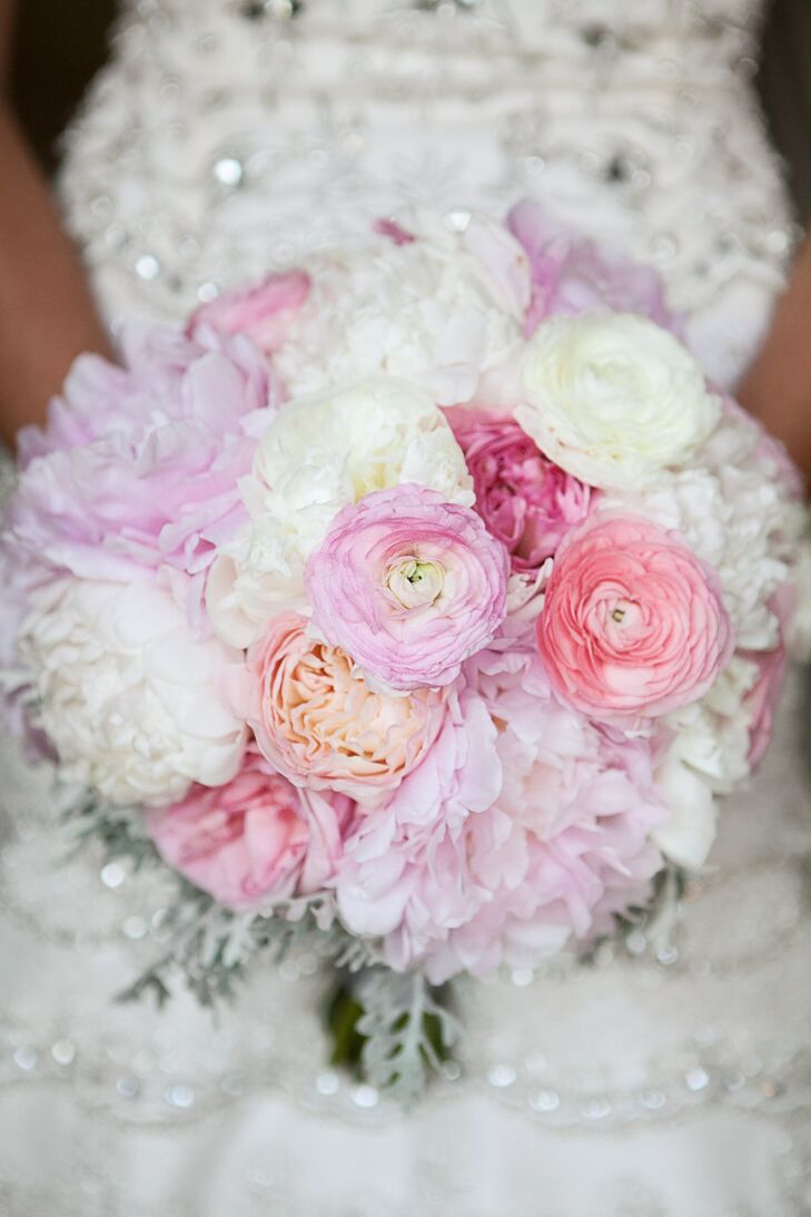 Katie carreid a light pink and white peony, ranunculus and cabbage rose bouquet. The florist added eucalyptus seed she painted silver to pick up the beadwork of Katie's dress.
