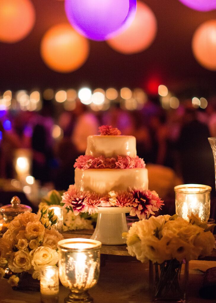 Nora and Michael were surprised by their two layer wedding cake by Nora's sister-in-law, Chef Hannah Galbreath. The bottom layer was Michael's favorite, chocolate cake with chocolate ganache, while top layer was for Nora, carrot cake with cream cheese frosting. The entire cake was covered in vanilla fondant and decorated with fresh flowers.