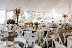 Tented Wedding Reception With Folding Chairs and Pampas Grass