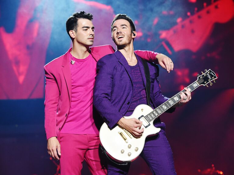Joe Jonas shows off his wedding ring while performing. 