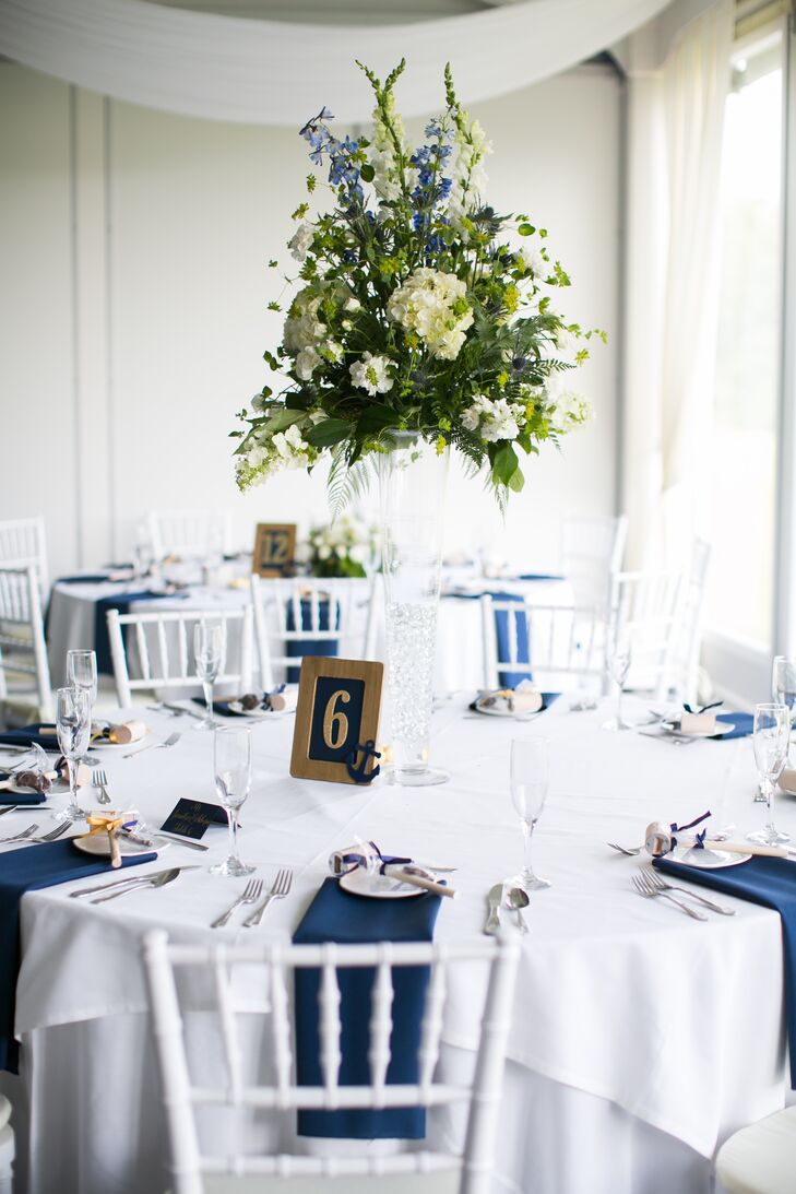 For the centerpieces from the Gateway Florist, they went with a more natural twist on the theme. Each low or tall arrangement was filled with white hydrangeas, white delphiniums, greenery, wildflowers and of course blue sea holly (to tie in their colors). The flowers seemed to top each clear-glass vase with no stems in sight. (How cool is that?)