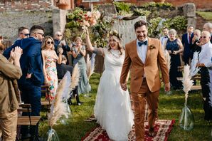 Bride and Groom Walking in Recessional on Rug Aisle Runner, Feathers in Vases for Boho-Chic Wedding