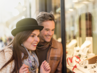Couple smiling while engagement ring shopping