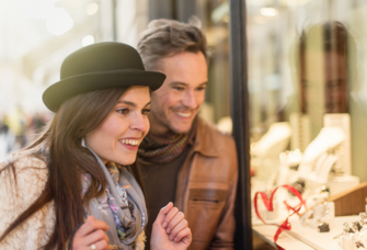 Couple smiling while engagement ring shopping
