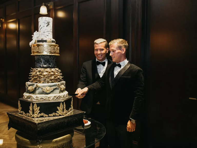 Eight-tier wedding cake with glam black, gold and marble accents