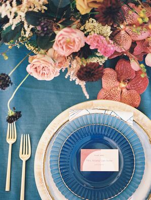 Place Setting on Table With Blue Linen, Chargers in Different Shades of Blue,  Gold Details, Geometric Name Card