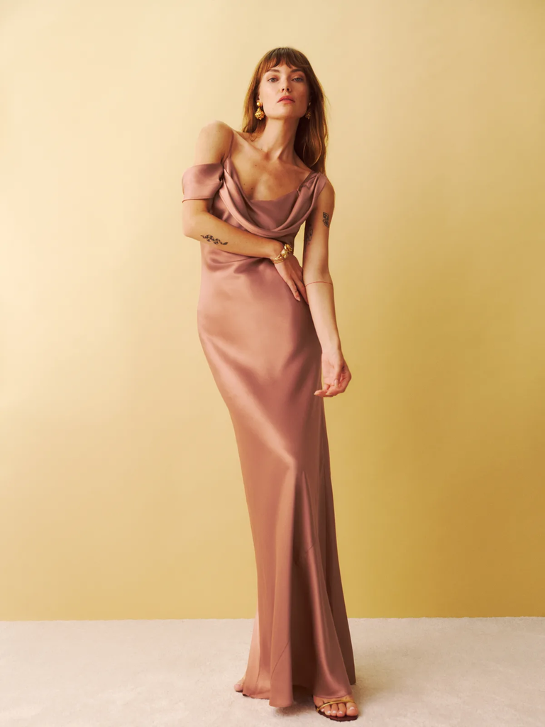 A model wears this floor-length sleeveless gown with a cowl neckline.