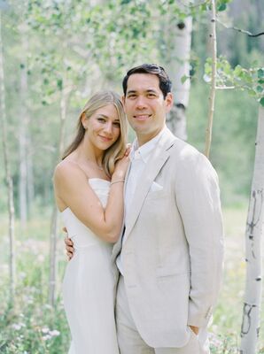 Bride in Simple Dress and Groom in Light Gray Suit Pose Amongst Aspen Trees