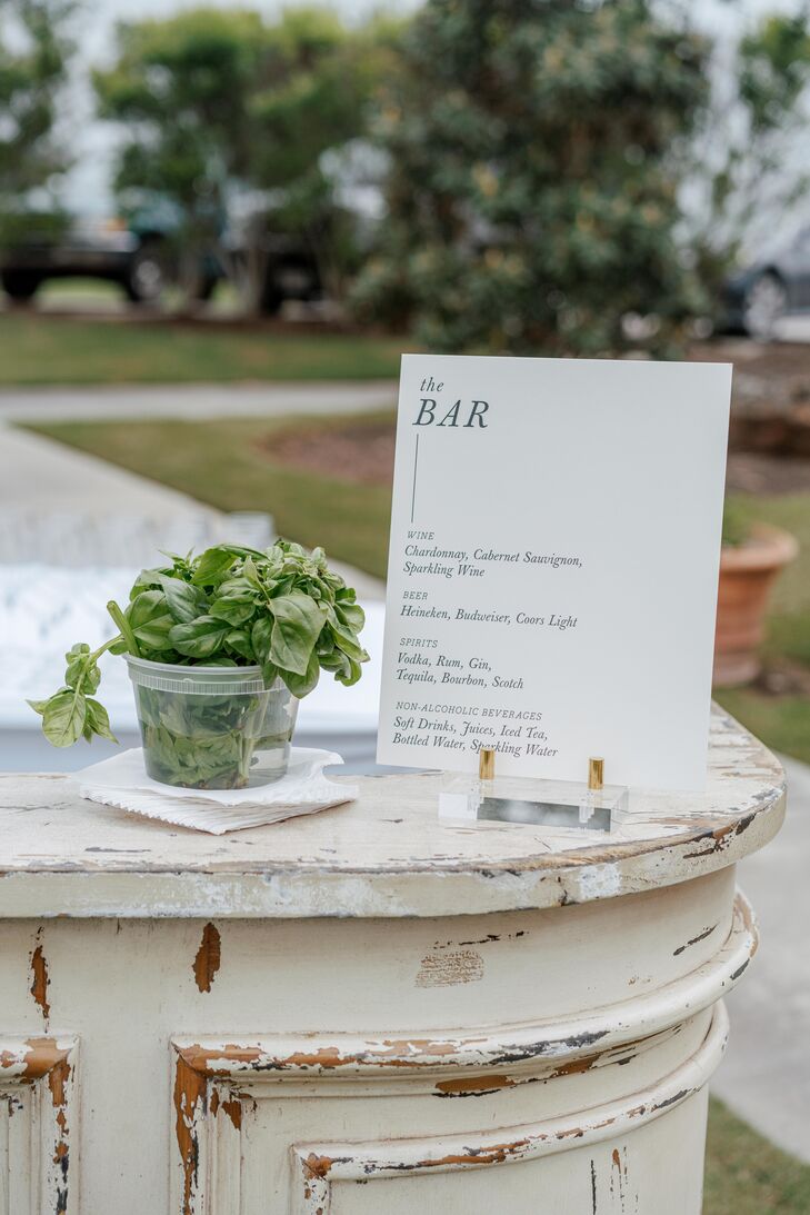 Modern Black-and-White Bar Sign Beside Bowl of Fresh Basil