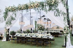 Glam Reception With Modern Black Chairs, White Draping and Modern Chandeliers