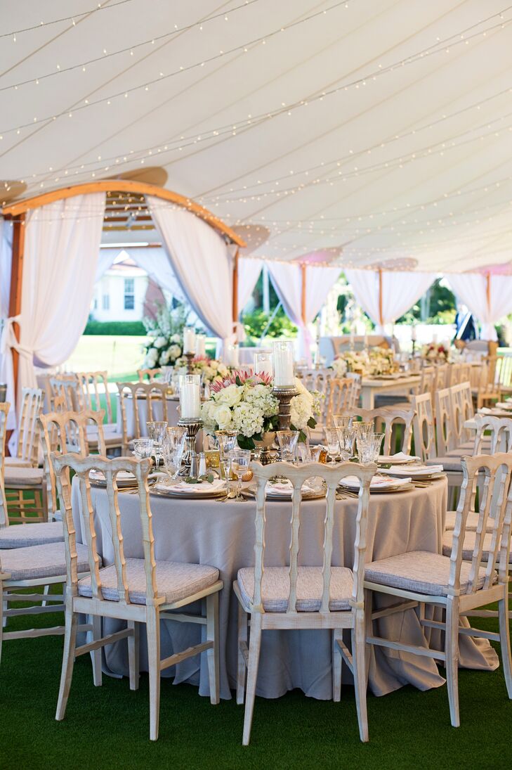 While gilded accents, pillar candles and bold bouquets of hydrangeas, roses and proteas arranged in footed bowls gave the reception a sense of elegance and refined flair, antiqued wooden chairs and a Sperry tent infused the decor with a subtle rustic note.