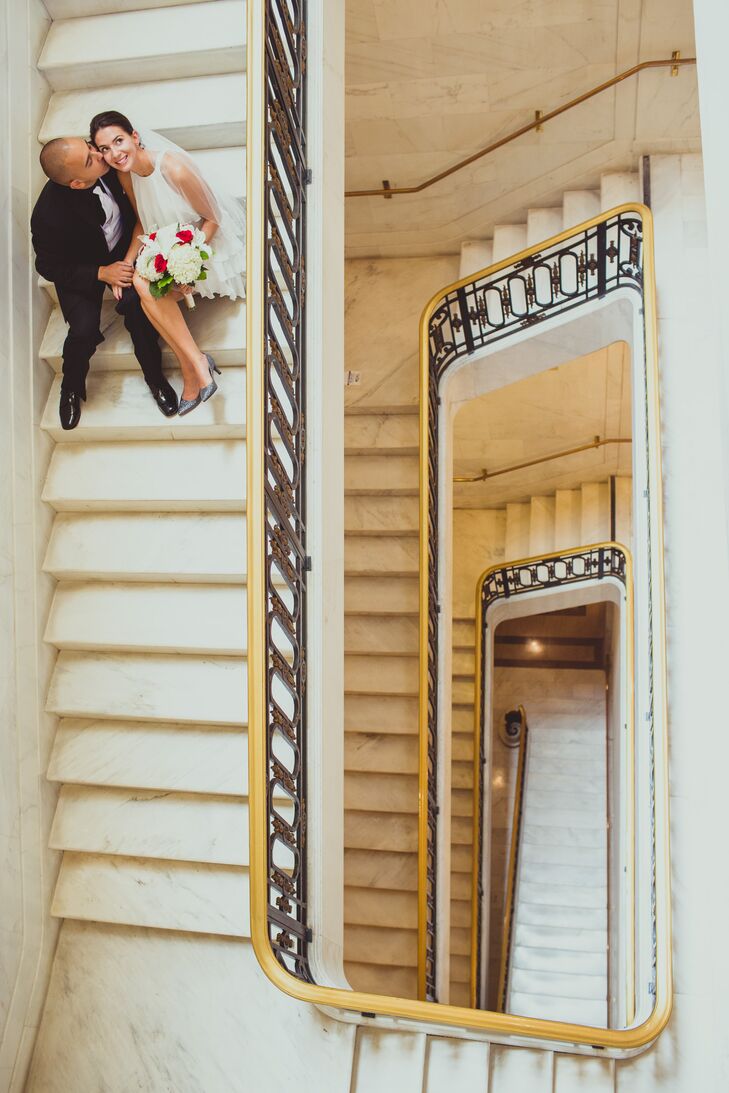 The bridal and groom sat on the marble steps of a square spiral staircase inside the San Francisco City Hall.